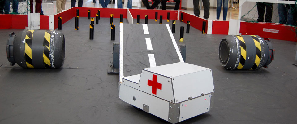 A robot takes on the ramp in the Rampaging Chariots assault course