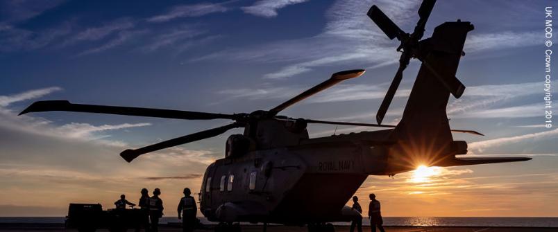 Silhouette of Merlin helicopter on deck of Royal Navy ship