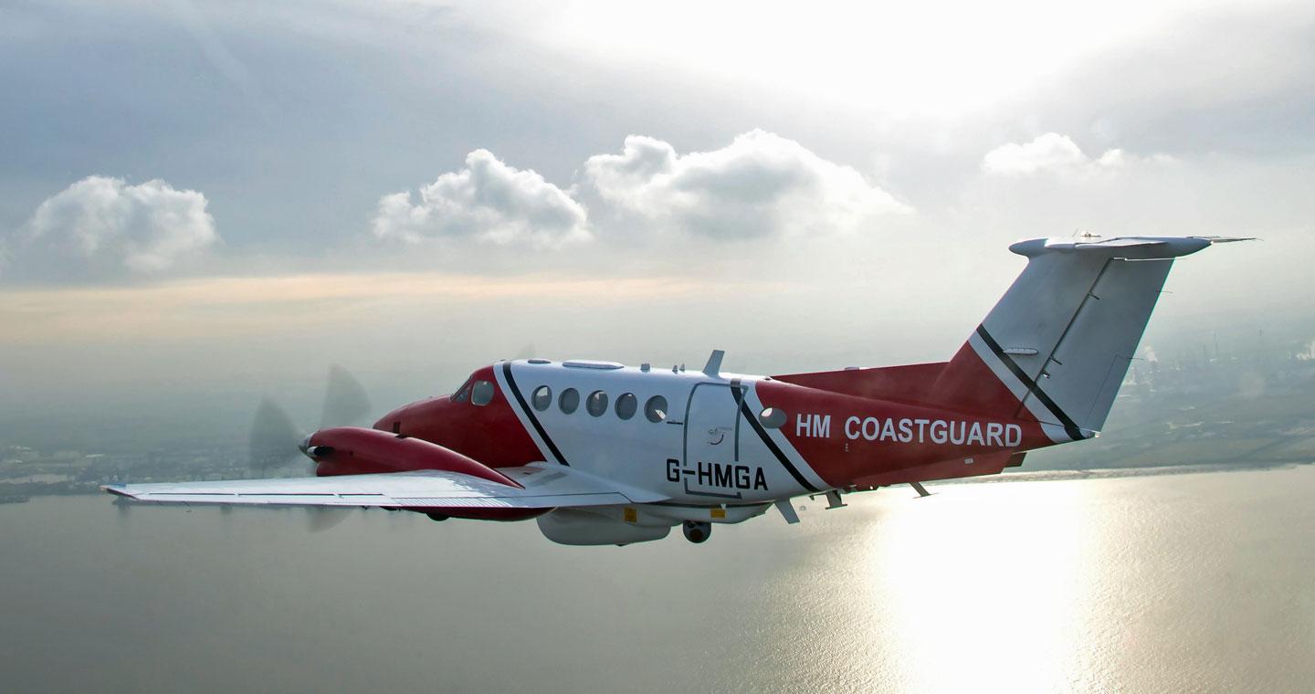 UK Maritime and Coastguard plane flying over the sea