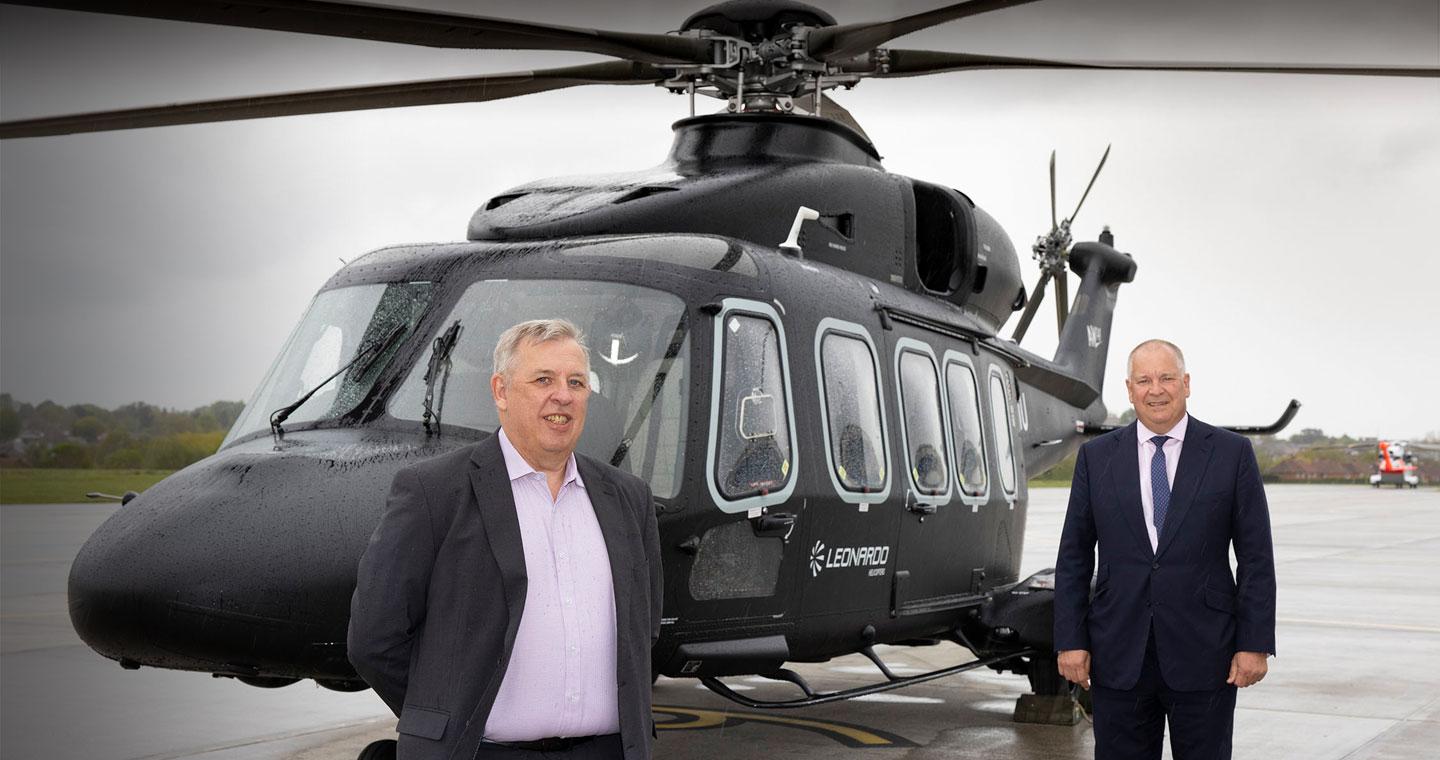 Norman Bone, Chair and Managing Director of Leonardo UK left and Nick Whitney, Managing Director of Leonardo Helicopters UK right alongside the AW149 helicopter