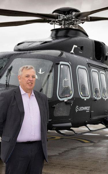 Norman Bone, Chair and Managing Director of Leonardo UK, alongside the AW149 helicopter