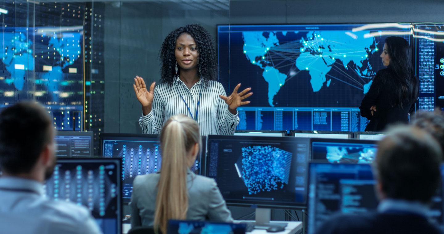 Cyber security expert briefs her team in a security operations centre