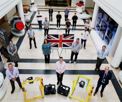 Members of the Miysis DIRCM team in Edinburgh stand proudly alongside the technology