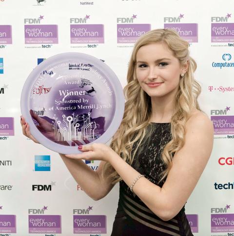Young woman engineer holds up glass plate, the Apprentice Award