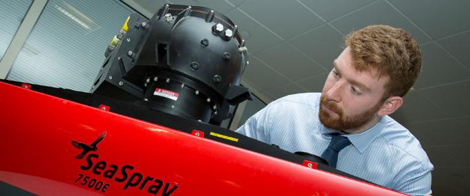 Young, bearded, male engineer works on SeaSpray radar