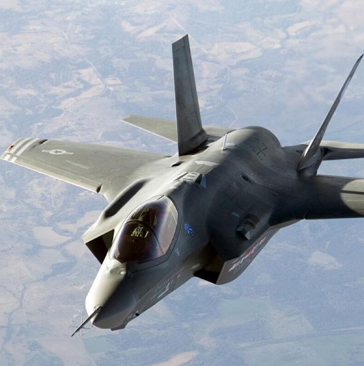 F35 in the air flying over land