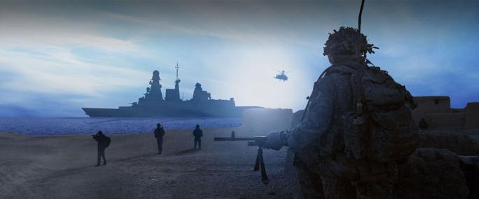 Troops on a coastline look out to sea where a large naval vessel is stationed